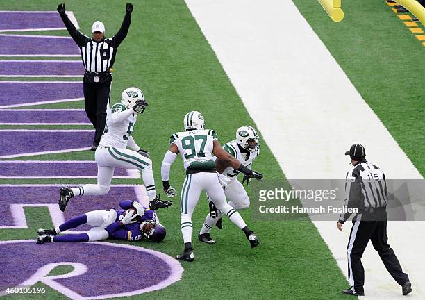 Teddy Bridgewater of the Minnesota Vikings lays in the end zone as Jason Babin, Calvin Pace and Sheldon Richardson of the New York Jets celebrate a...