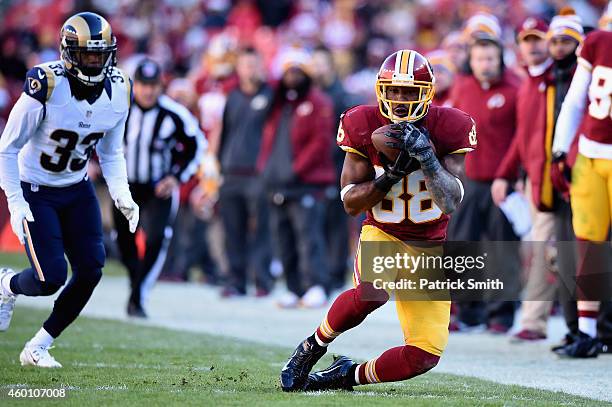 Wide receiver Pierre Garcon of the Washington Redskins makes a second quarter catch against the defense of cornerback E.J. Gaines of the St. Louis...