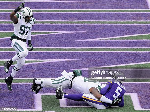 Calvin Pace of the New York Jets celebrates as teammate Sheldon Richardson sacks Teddy Bridgewater of the Minnesota Vikings in the end zone for a...