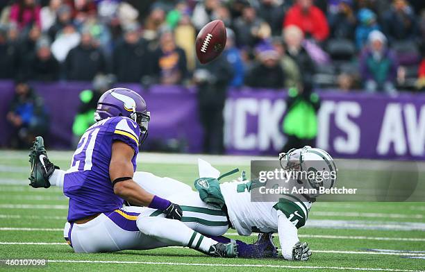 Josh Robinson of the Minnesota Vikings breaks up a pass intended Chris Owusu of the New York Jets in the second quarter on December 7, 2014 at TCF...
