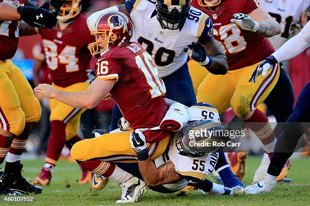 Middle linebacker James Laurinaitis of the St. Louis Rams sacks quarterback Colt McCoy of the Washington Redskins in the second quarter of a game at...