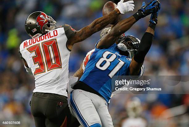 Calvin Johnson of the Detroit Lions breaks up a first quarter catch in front of Bradley McDougald of the Tampa Bay Buccaneers at Ford Field on...