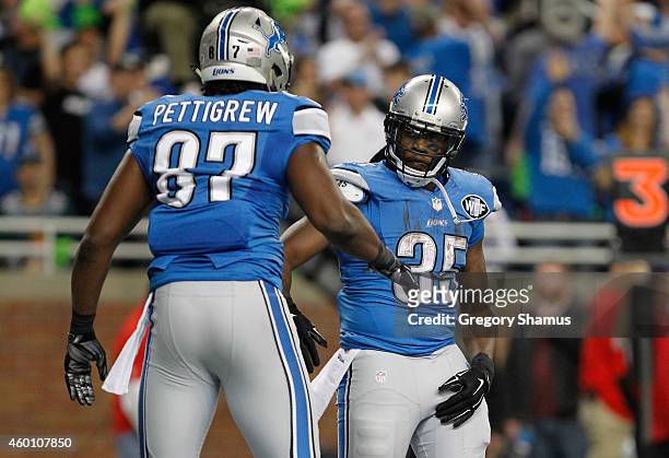 Joique Bell and Brandon Pettigrew of the Detroit Lions celebrate a second quarter touchdown against the Tampa Bay Buccaneers at Ford Field on...