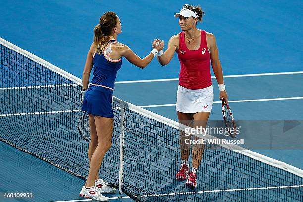 Sam Stosur of Australia shakes hands with Agnieszka Radwanska of Poland after defeating her in the women's singles match during day six of the Hopman...