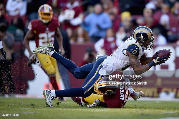 Wide receiver Stedman Bailey of the St. Louis Rams is stopped just short of the goal line by cornerback David Amerson of the Washington Redskins in...