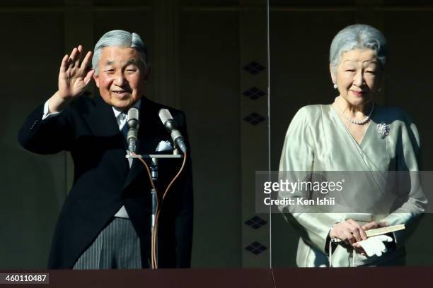 Emperor Akihito waves to well-wishers next to Empress Michiko during celebrations for the New Year on the veranda of the Imperial Palace on January...