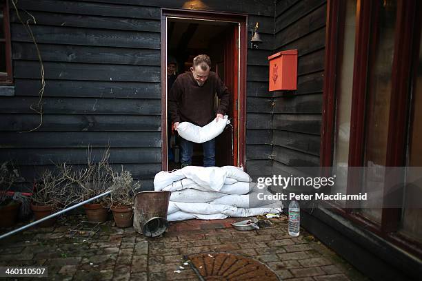 Resident Jeff Hopcroft prepares his house against further flooding on January 2, 2014 in Yalding, England. Government ministers are holding a COBRA...