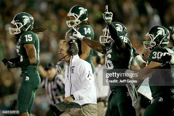 Head coach Mark Dantonio and the Michigan State Spartans celebrate stopping the Stanford Cardinal on fourth down to take possesion in the final...