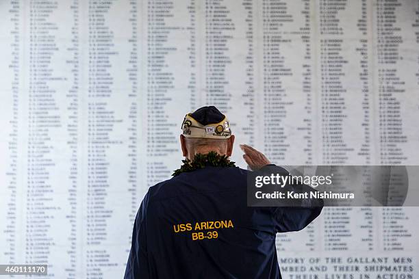 Arizona survivor Louis Conter salutes the remembrance wall of the U.S.S. Arizona during a memorial service for the 73rd anniversary of the attack on...