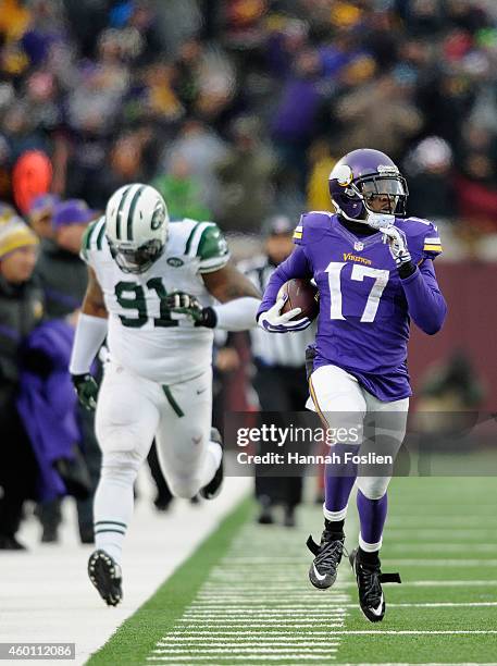 Jarius Wright of the Minnesota Vikings carries the ball for a touchdown as Sheldon Richardson gives chase during overtime of the New York Jets of the...
