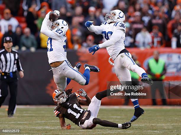 Josh Gordy intercepts a pass intended for Travis Benjamin of the Cleveland Browns alongside LaRon Landry of the Indianapolis Colts during the fourth...