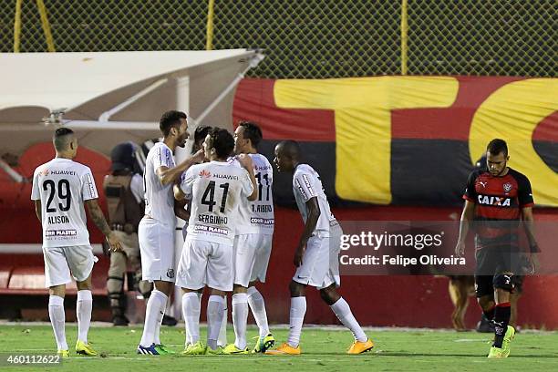 Thiago Ribeiro of Santos is mobbled by his team mates after scoring their goal against Vitoria during the match between Vitoria and Santos as part of...