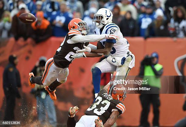 Hilton of the Indianapolis Colts can't make a catch between the defense of Buster Skrine and Jordan Poyer of the Cleveland Browns during the fourth...