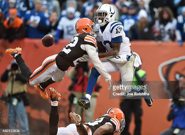 Josh Gordy intercepts a pass intended for Travis Benjamin of the Cleveland Browns alongside LaRon Landry of the Indianapolis Colts during the fourth...
