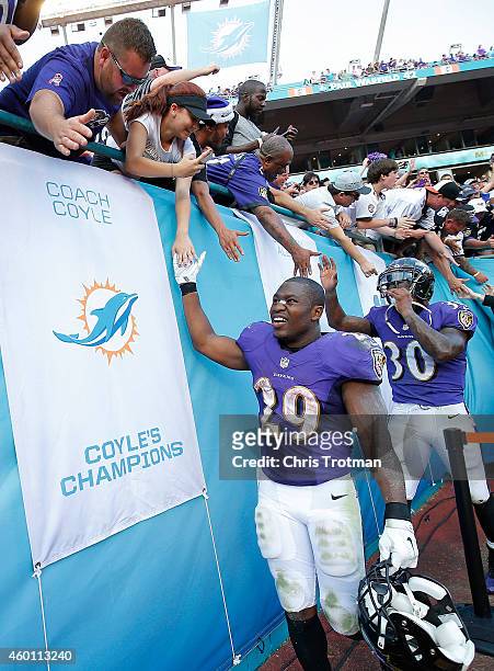 Running back Justin Forsett of the Baltimore Ravens and running back Bernard Pierce greet fans after their team's 28-13 win over the Miami Dolphins...