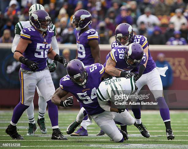 Jasper Brinkley, Robert Blanton and Harrison Smith of the Minnesota Vikings tackle Percy Harvin of the New York Jets in the fourth quarter on...