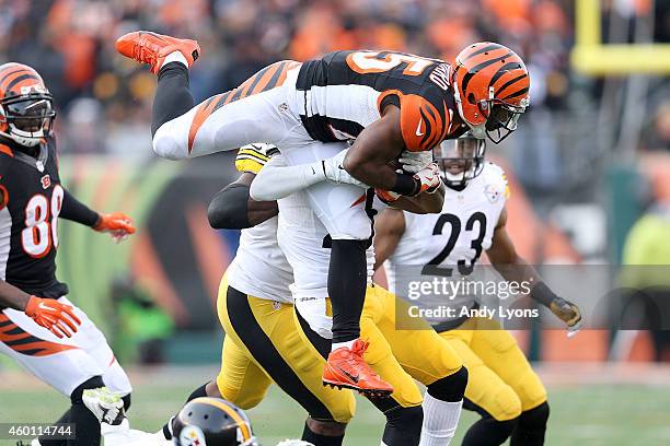 Giovani Bernard of the Cincinnati Bengals is tackled by Brice McCain of the Pittsburgh Steelers during the fourth quarter at Paul Brown Stadium on...