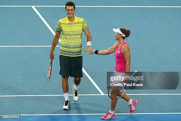 Bernard Tomic and Sam Stosur of Australia celebrate winning a game in the mixed doubles match against Grzegorz Panfil and Agnieszka Radwanska of...