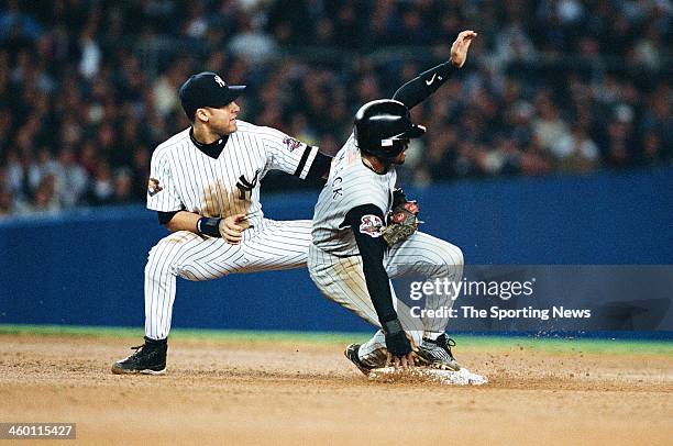 Derek Jeter of the New York Yankees defends against Tony Womack of the Arizona Diamondbacks during Game Five of the World Series on November 1, 2001...