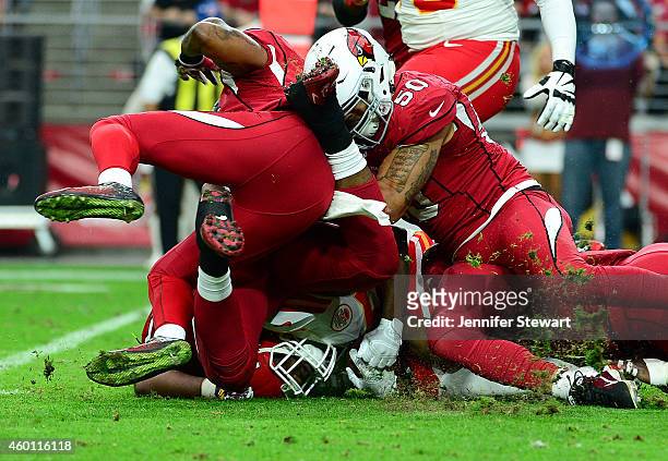 Running back Jamaal Charles of the Kansas City Chiefs is tacked by middle linebacker Larry Foote of the Arizona Cardinals and free safety Rashad...