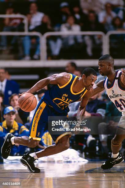 Latrell Sprewell of the Golden State Warriors dribbles the ball against Calbert Cheaney of the Washington Bullets circa 1997 at the Oakland-Alameda...