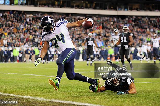 Marshawn Lynch of the Seattle Seahawks runs 15 yards for a touchdown against Nate Allen of the Philadelphia Eagles during the third quarter of the...