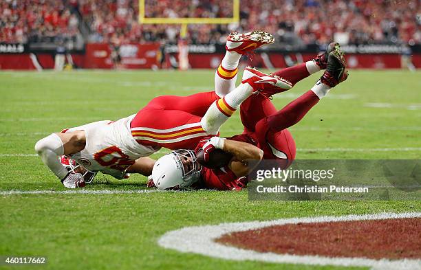 Tight end John Carlson of the Arizona Cardinals is hit by inside linebacker Josh Mauga of the Kansas City Chiefs on a two-point conversion attempt in...