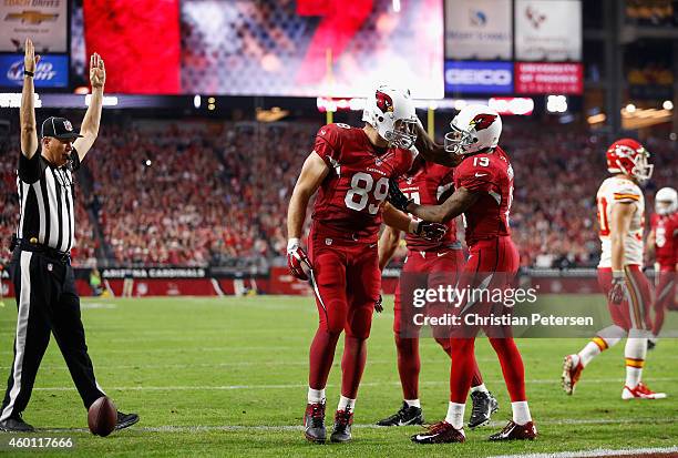 Tight end John Carlson of the Arizona Cardinals celebrates a two-point conversion with wide receiver Ted Ginn and wide receiver Larry Fitzgerald...