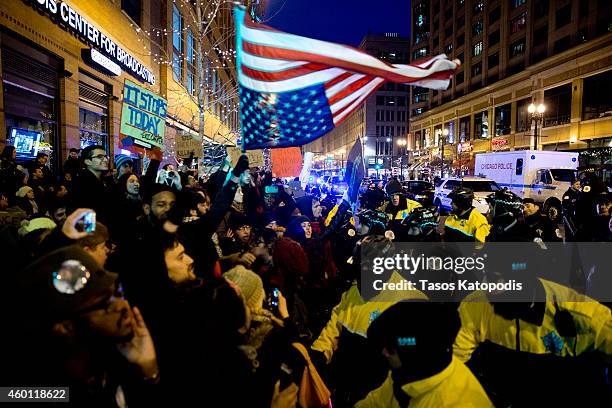 Protesters clash with the Chicago police in the street after recent grand jury decisions in police-involved deaths on December 7, 2014 in Chicago,...