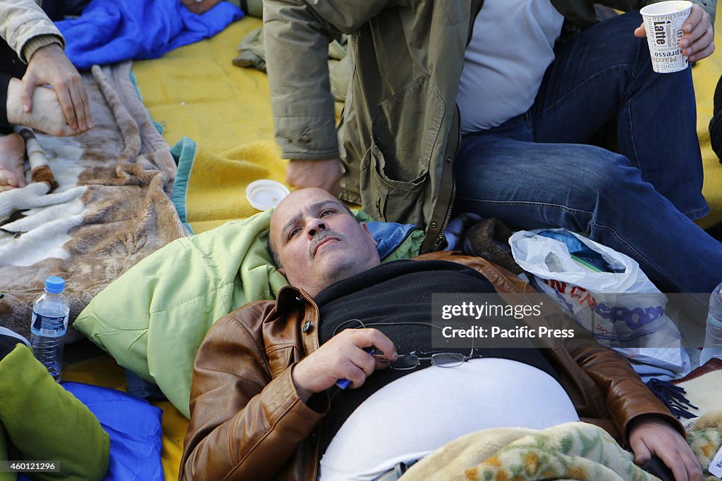 The Greek MP Ioannis Michelogiannakis lies on the ground...