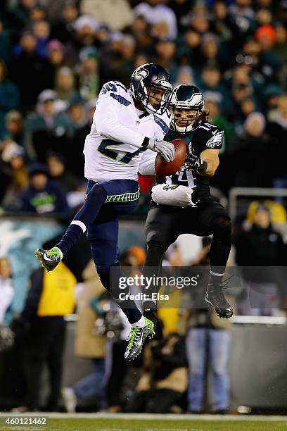 Tharold Simon of the Seattle Seahawks intercepts a pass intended for Riley Cooper of the Philadelphia Eagles during the second half of the game at...