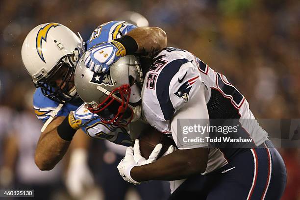 Running back LeGarrette Blount of the New England Patriots is tackled by outside linebacker Jarret Johnson of the San Diego Chargers at Qualcomm...