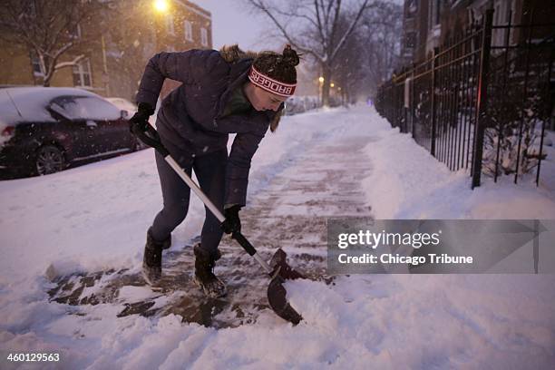 Toni Zakarija shovels the sidewalk at her home on Evergreen Avenue in Wicker Park, Thursday, Jan. 2 in Chicago.