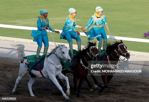 Omani horse riders show their skills during the annual Royal Horse Racing Festival in Muscat on January 2, 2014. The shows were presented by male and...