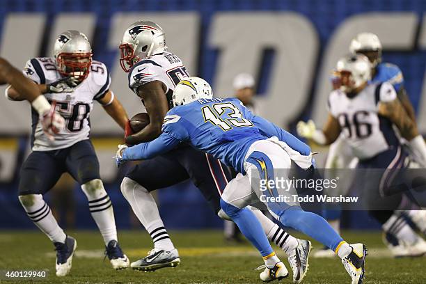 Outside linebacker Akeem Ayers of the New England Patriots intercepts the football and is tackled by intended receiver wide receiver Keenan Allen of...