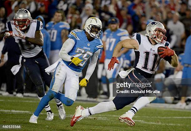 Julian Edelman of the New England Patriots runs for a touchdown against Shareece Wright of the San Diego Chargers during an NFL game at Qualcomm...