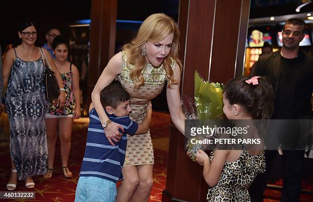 Australian actress Nicole Kidman gets a hugs from a young boy before a special screening of her new film "Paddington" for children being treated at...