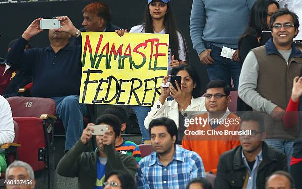 Fans display banners as Roger Federer of the Indian Aces plays against Tomas Berdych of the Singapore Slammers during the Coca-Cola International...