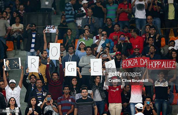 Fans display banners as Roger Federer of the Indian Aces plays against Tomas Berdych of the Singapore Slammers during the Coca-Cola International...