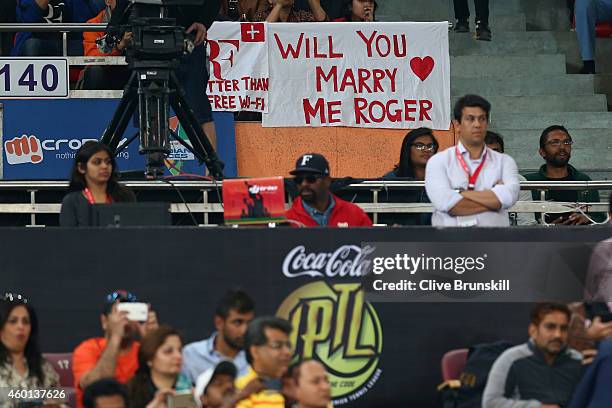 Fans display banners as Roger Federer of the Indian Aces plays against Tomas Berdych of the Singapore Slammers during the Coca-Cola International...