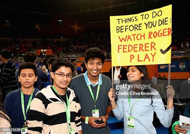 Fans display banners as Roger Federer of the Indian Aces plays against Tomas Berdych of the Singapore Slammers during the Coca-Cola International...