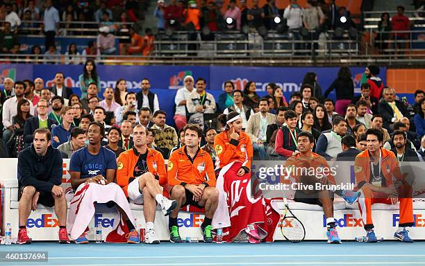 Pete Sampras and Gael Monfils sit on the Indian Aces team bench during their teams match against the Singapore Slammers during the Coca-Cola...