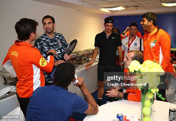 Pete Sampras and Roger Federer of the Indian Aces meet with team mates in the players lounge as they make their debut for the Indian Aces against the...