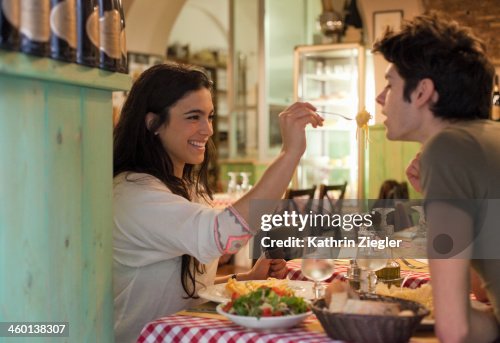 Happy young couple eating together in restaurant Happy young couple eating together in restaurant