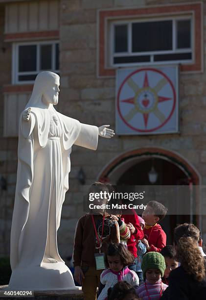 Displaced Iraqi Christian children, who were forced to flee their homes as the Islamic State advanced earlier this year, arrive for an afternoon of...