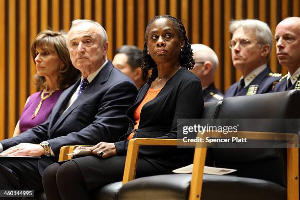 New York City Mayor Bill de Blasio's wife, Chirlane McCray, sits on stage with William Bratton, just sworn in as New York City's 42nd police...