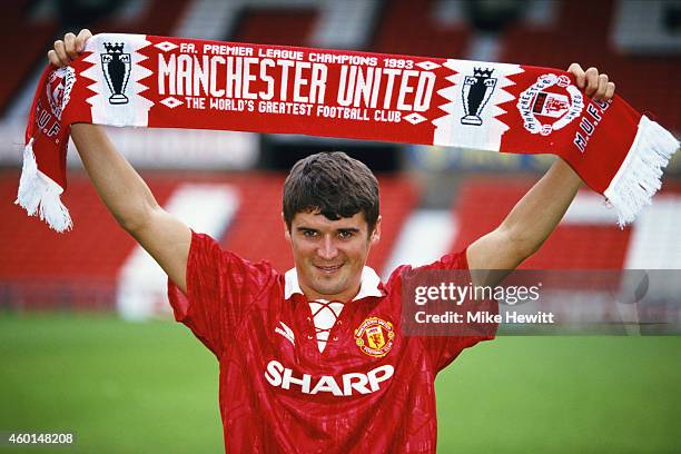 New Manchester United signing Roy Keane poses with a club scarf at Old Trafford after signing from Nottingham Forest ahead of the 1993/94 season.