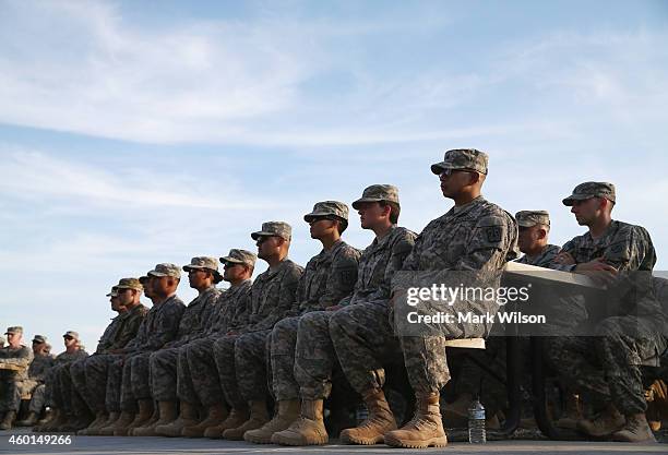 Troops listen to Secretary of Defense Chuck Hagel speak during a visit, December 8, 2014 at Camp Buehring, Kuwait. Secretary Hagel visited the camp...