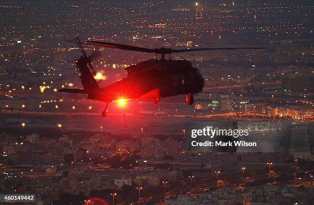 Blackhawk helicopter from Bravo Co 2/147th AVN Renegades flies support for U.S. Secretary of Defense Chuck Hagel, December 8, 2014 over Kuwait City,...