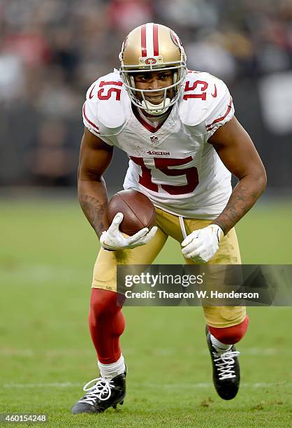 Michael Crabtree of the San Francisco 49ers runs with the ball against the Oakland Raiders in the third quarter at O.co Coliseum on December 7, 2014...